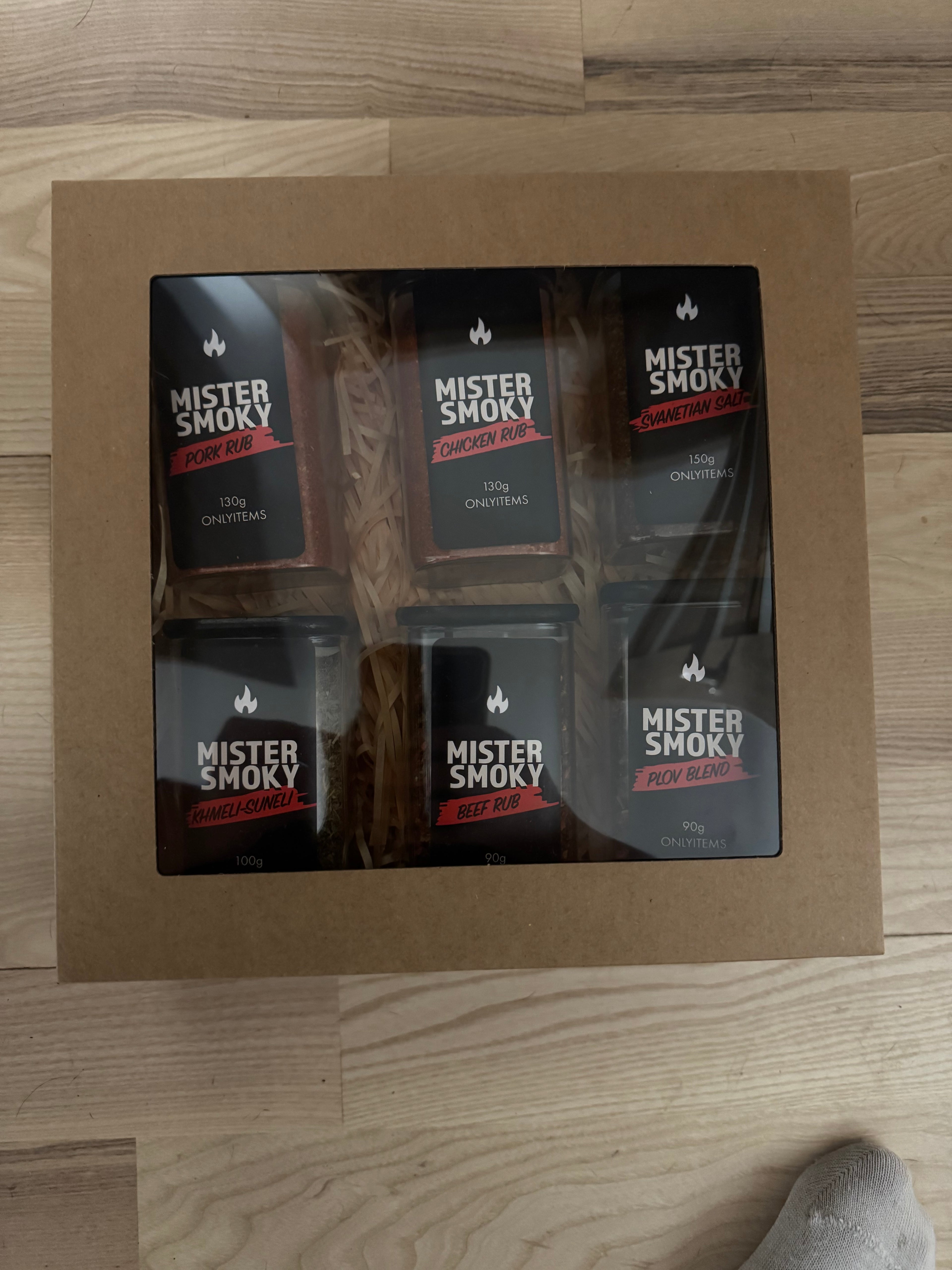 Box of Mister Shock products on a wooden floor